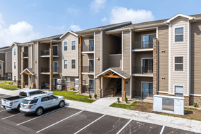 Kansas City apartment for rent - A row of apartment buildings with a car parked in front.