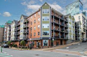 Halifax apartment for rent - A street view of a multi-story building with a red stop sign in front of it.