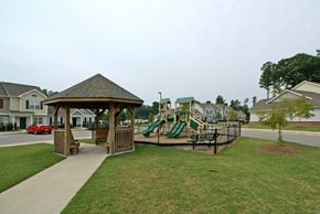 Goldsboro apartment for rent - A gazebo is in the middle of a playground with a slide.