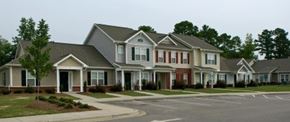 Goldsboro apartment for rent - A row of houses with a driveway in front.