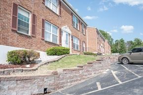 St. Louis apartment for rent - A brick building with a car parked in front.