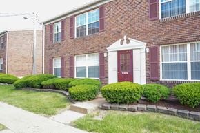 St. Louis apartment for rent - A red brick house with a white door and windows.