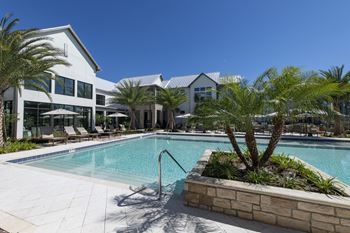 Lake side resort-style pool with cabana beds