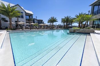 Lake side resort-style pool with cabana beds