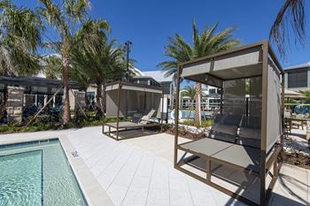 Lake side resort-style pool with cabana beds
