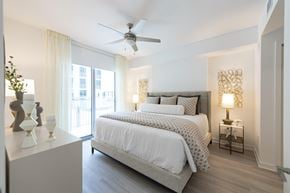 Miami apartment for rent - A bedroom with a large bed and a ceiling fan.