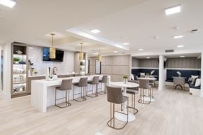 Miami apartment for rent - A modern dining area with a bar and seating.