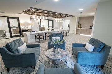 Miami apartment for rent - A modern living room with grey couches and a wooden ceiling.
