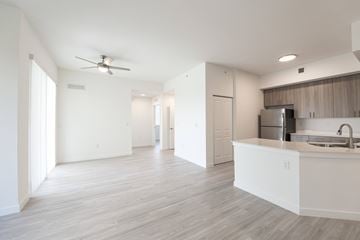 Miami apartment for rent - A spacious kitchen with a white countertop and a ceiling fan.