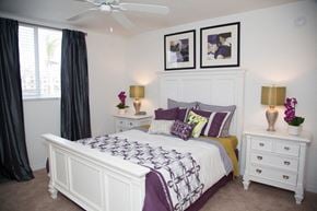 Pompano Beach apartment for rent - A bedroom with a bed, nightstands, and a ceiling fan.