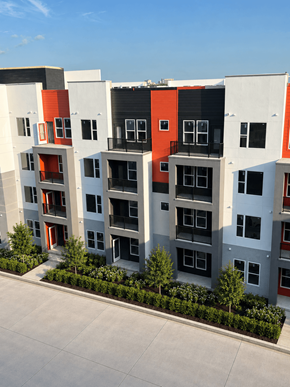 Orlando apartment for rent - A modern apartment building with balconies and trees in front.