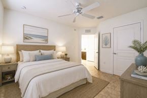 Homestead apartment for rent - A bedroom with a large bed and a ceiling fan.