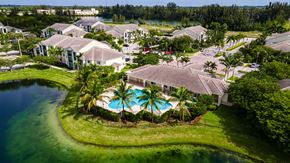 Homestead apartment for rent - an aerial view of a resort with a pool and palm trees