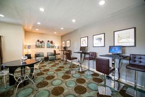 Homestead apartment for rent - a conference room with tables and chairs and a computer