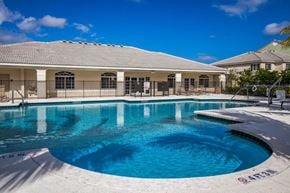 Homestead apartment for rent - a swimming pool with a house in the background