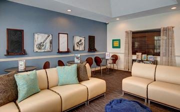 Homestead apartment for rent - a living room with couches and chairs and paintings on the wall