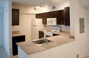 Homestead apartment for rent - a kitchen with a sink a stove and a refrigerator