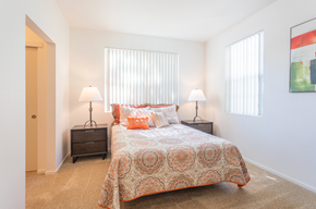 Salinas apartment for rent - A bedroom with a bed, two lamps, and a painting on the wall at Palm Court Apartments, Salinas
