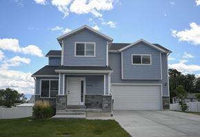 Magna apartment for rent - a blue house with a driveway and a white garage door