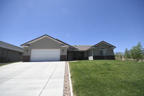 Toquerville apartment for rent - a house with a driveway and lawn in front of it