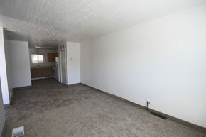 Wendover apartment for rent - an empty living room and kitchen with white walls and flooring