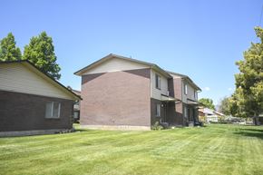American Fork apartment for rent - a brick house with a yard in front of it