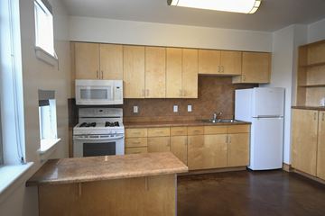 Park City apartment for rent - an empty kitchen with white appliances and wooden cabinets