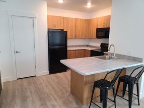 Park City apartment for rent - a kitchen with a island and a black refrigerator