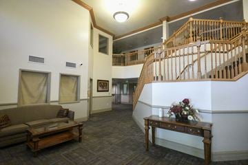 Logan apartment for rent - a living room with a staircase and a couch
