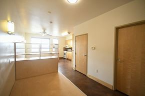Park City apartment for rent - an empty living room with a door to a bedroom and a kitchen