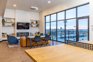 Salt Lake City apartment for rent - a living room with a table and chairs and a large window with a city view
