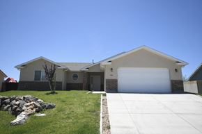 Toquerville apartment for rent - a house with a white garage door and a lawn