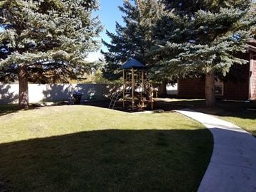 Park City apartment for rent - a playground in the yard of a home on a sunny day