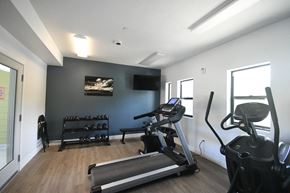 Moab apartment for rent - a gym with exercise equipment and a wall mounted tv
