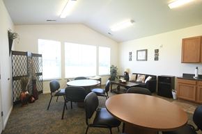 Heber City apartment for rent - a dining room with tables and chairs and a large window