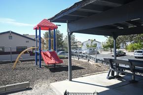 Wendover apartment for rent - a playground with a red swing set in a park