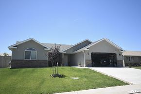 Toquerville apartment for rent - a house with a driveway and a lawn in front of it
