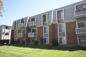 Salt Lake City apartment for rent - an apartment building with a green lawn in front of it