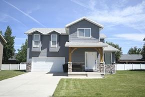Heber apartment for rent - a blue house with a white garage door and a lawn