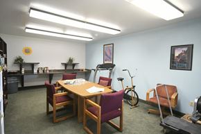 Salt Lake City apartment for rent - a conference room with a table and chairs and a bike in the corner