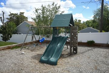 Magna apartment for rent - a playground with a swing set and a slide