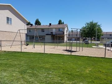 Roosevelt apartment for rent - a playground in front of a house with a swing set