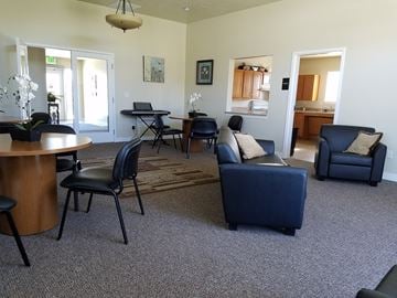 Tremonton apartment for rent - a living room with couches and chairs and a table and a kitchen