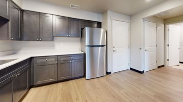 Smithfield apartment for rent - A kitchen with a refrigerator, cabinets, and a counter.