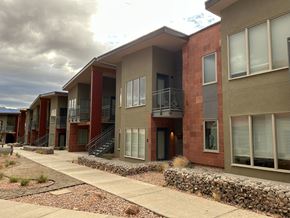 Moab townhouse for rent - A row of modern houses with red brick and beige walls.