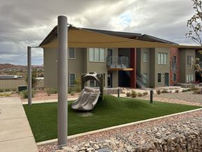 Moab townhouse for rent - A playground area in front of a modern apartment building.