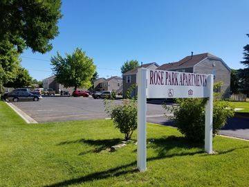 Vernal apartment for rent - a sign in the grass in front of a parking lot