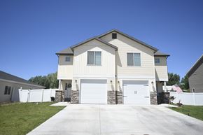 Cedar City apartment for rent - a white house with white doors and a driveway