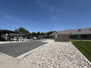 Smithfield apartment for rent - A parking lot with a gravel area in front of a building.