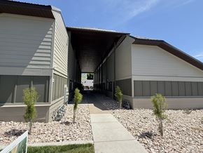 Smithfield apartment for rent - A modern building with a gravel pathway leading to the entrance.
